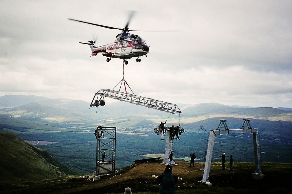 A helicopter airlifts parts in during construction of the resort