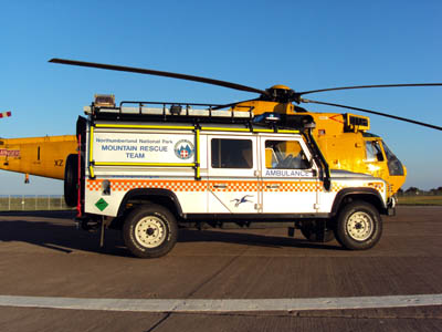 The new Land Rover alongside an RAF search and rescue Sea King helicopter