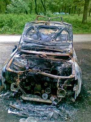 A burnt-out car in the forest at Sallochy