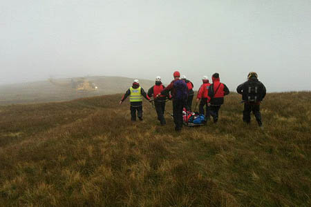 Rescuers stretcher the walkers to the waiting helicopter. Photo: Penrith MRT Rescuers stretcher the walkers to the waiting helicopter. Photo: Penrith MRT
