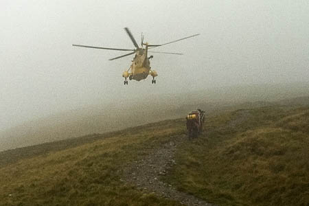 The RAF Sea King and rescuers make their way up the hillside in difficult conditions. Photo: Penrith MRT The RAF Sea King and rescuers make their way up the hillside in difficult conditions. Photo: Penrith MRT