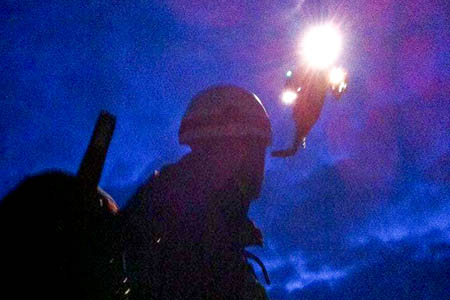 A Penrith MRT member with a helicopter as night draws in A Penrith MRT member with a helicopter as night draws in