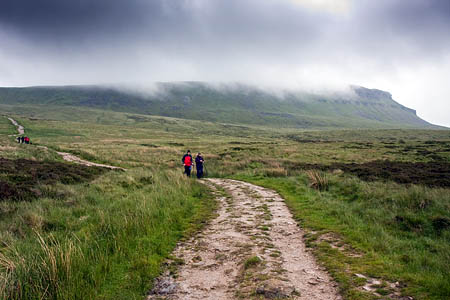 Walkers descend Pen-y-ghent, one of Yorkshire's Three Peaks Walkers descend Pen-y-ghent, one of Yorkshire's Three Peaks