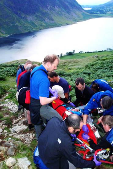 Rescuers with the injured walker on Rannerdale Knotts. Photo: Cockermouth MRT