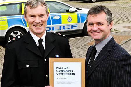 Chief Superintendent Chris Hardern presents Richard Hey with his commendation Chief Superintendent Chris Hardern presents Richard Hey with his commendation