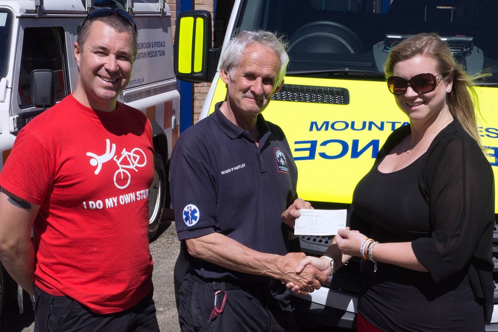 Neil and Becky Robinson present the cheque to Roger Hartley of the team