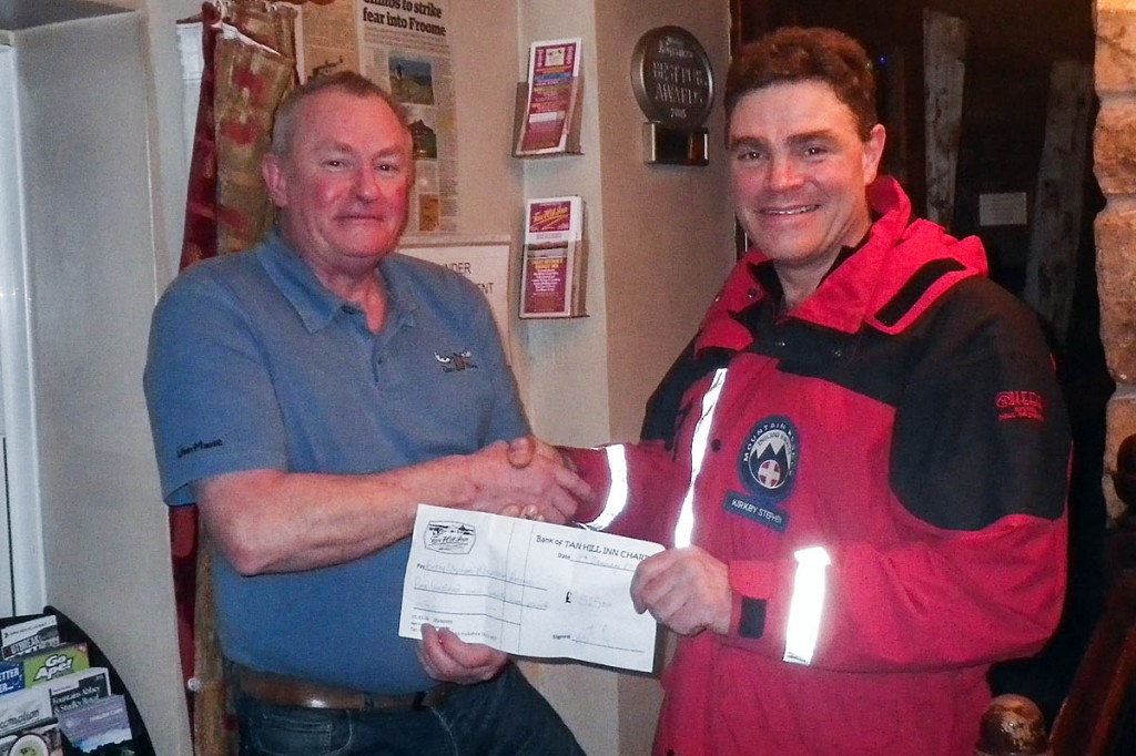 Roger Staniland hands over a cheque to team leader Adrian Cottrell 