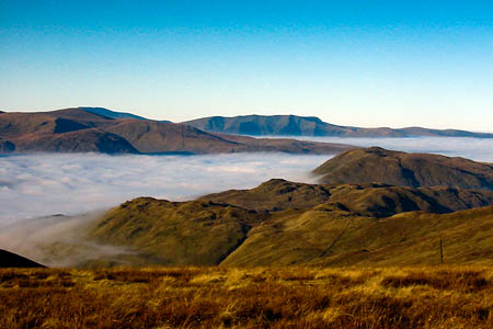 A temperature inversion in the Lake District, with cloud filling the valleys below sunny peaks A temperature inversion in the Lake District, with cloud filling the valleys below sunny peaks
