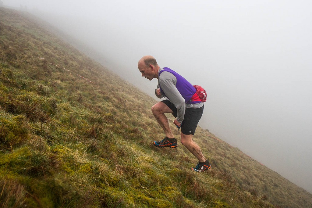 Last year's joint Fellsman winner Kim Collison makes the ascent to Whernside's summit, this time in the Three Peaks Race