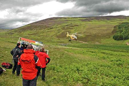 Tweed Valley MRT members and the air ambulance at the incident site Tweed Valley MRT members and the air ambulance at the incident site
