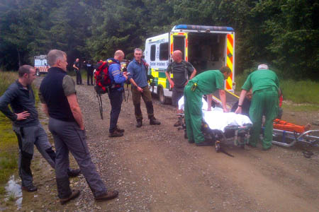 The mountain biker is transferred to an ambulance. Photo: Tweed Valley MRT The mountain biker is transferred to an ambulance. Photo: Tweed Valley MRT