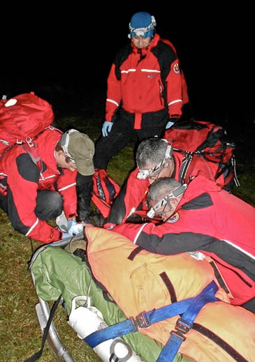 Rescuers with the walker on the Southern Upland Way. Photo: Tweed Valley MRT Rescuers with the walker on the Southern Upland Way
