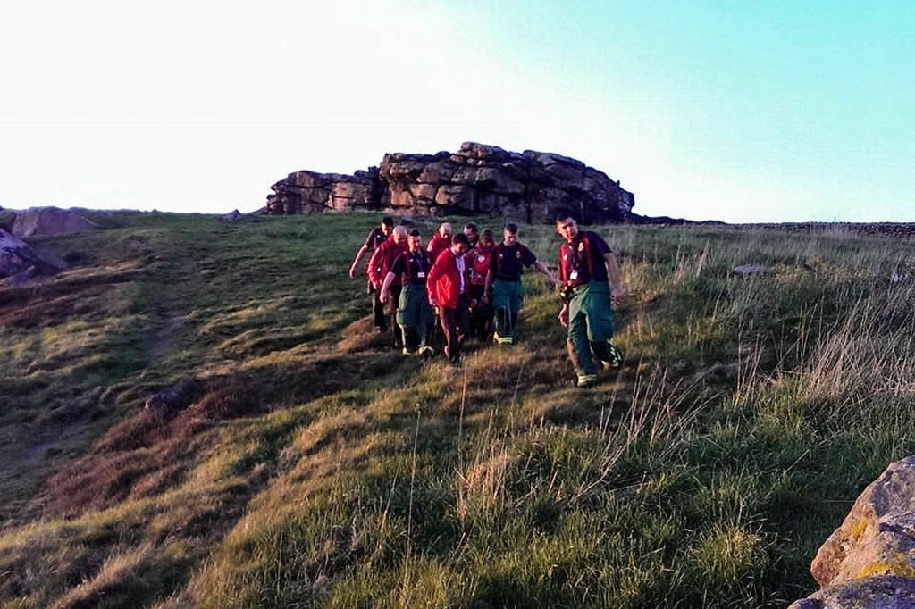 Team members stretcher the climber to the ambulance. Photo: UWFRA