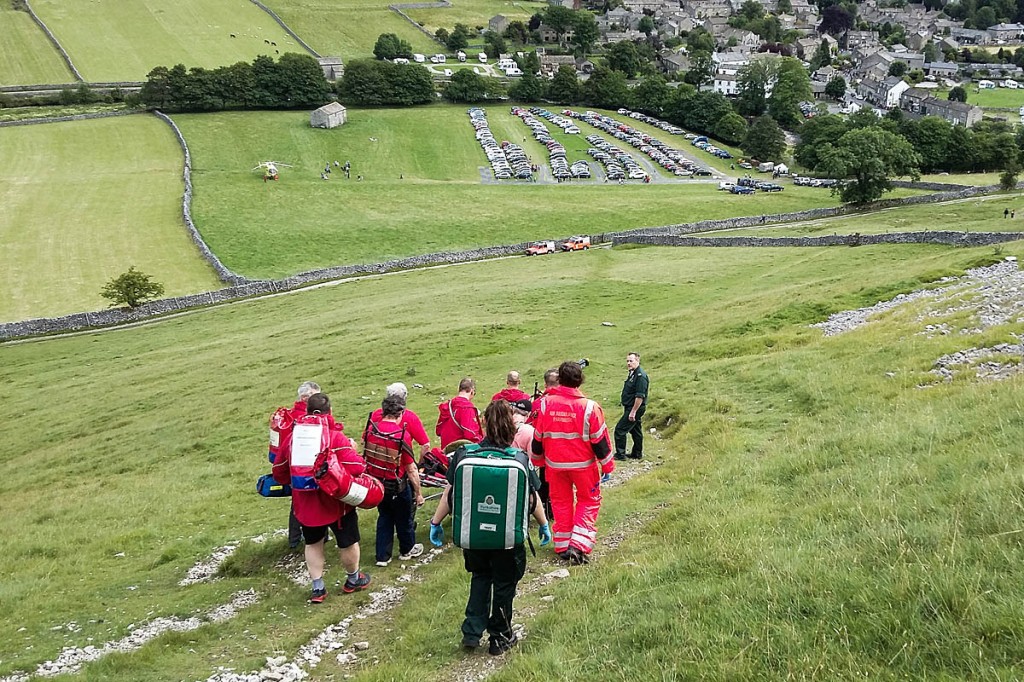 The walker is stretchered to the valley and the waiting air ambulance. Photo: UWFRA The walker is stretchered to the valley and the waiting air ambulance. Photo: UWFRA