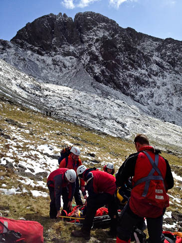 Rescuers treat one of the walkers on the slopes of Scafell Pike. Photo: Wasdale MRT Rescuers treat one of the walkers on the slopes of Scafell Pike. Photo: Wasdale MRT