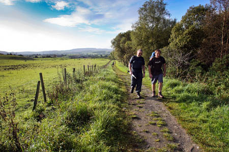 Walkers on the West Highland Way approaching Garadhban Forest Walkers on the West Highland Way approaching Garadhban Forest