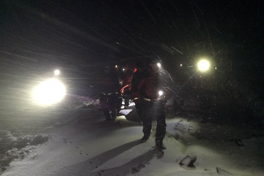 Team members stretcher the hypothermic walker from the moors. Photo: Woodhead MRT Team members stretcher the hypothermic walker from the moors. Photo: Woodhead MRT